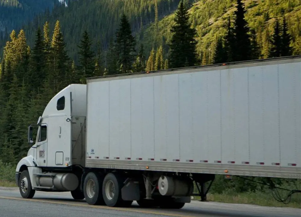 A truck hauling cargo down a highway